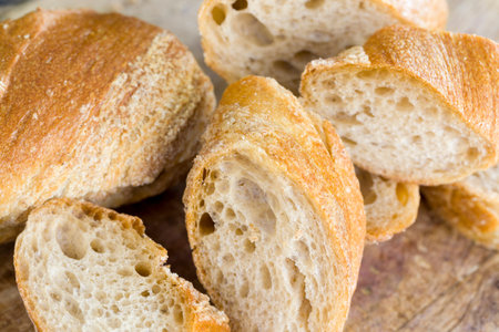 light baguette of rye flour, close-up of food on the kitchen cutting Board, cooking lunch of crispy...