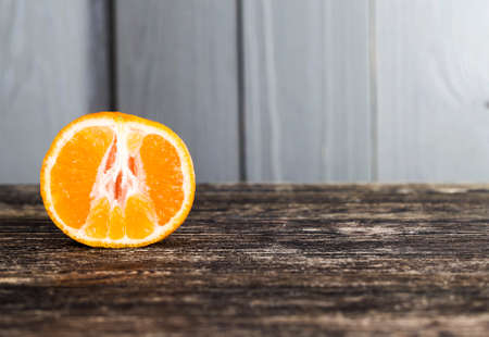 pulp of sweet and ripe orange close-up, useful citrus fruit, orange on a wooden tableの写真素材