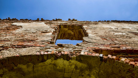 empty window openings in an abandoned ruined red brick building, closeup