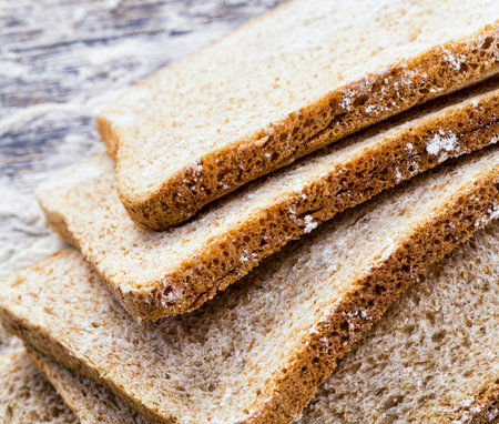 sliced fresh bread in white wheat flour, close-up of food on the table