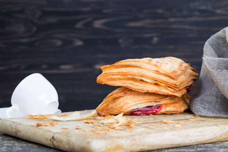 homemade bun made from flour and filling in the form of cherry red jamの写真素材