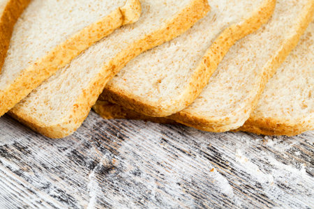 sliced fresh bread in white wheat flour, close-up of food on the table
