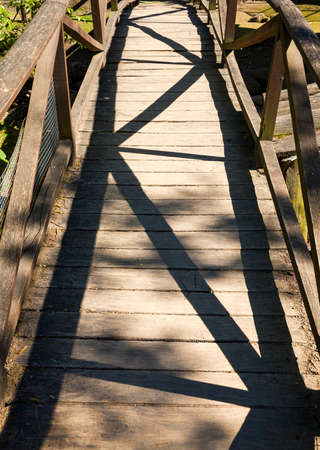 an old ordinary wooden bridge made in the villageの写真素材