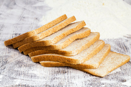sliced fresh bread in white wheat flour, close-up of food on the table
