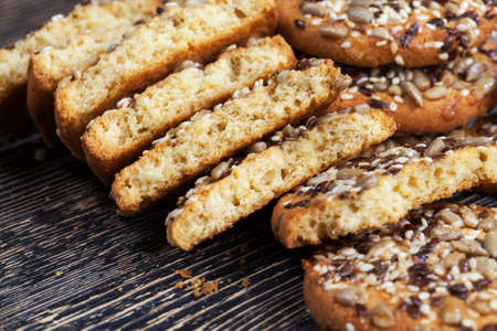 delicious fresh cookies made from high-quality oatmeal with flax and sunflower seeds and nuts, close-up of food broken into several partsの写真素材