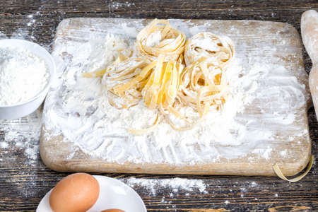 raw pasta with flour and other ingredients for cooking food, close-up in the kitchenの写真素材