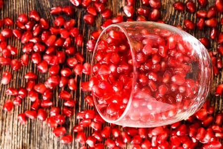 red juicy pomegranate seeds are red, pomegranate seeds are ready for eating lie in a glass glassの写真素材