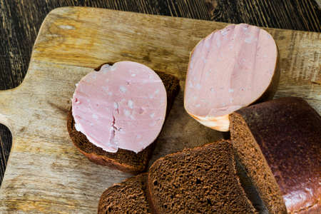 bread with sausage and butter, from which you can make sandwiches, close-up of food at homeの写真素材