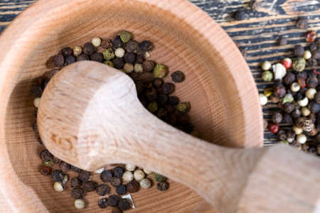 simple round wooden mortar for grinding dried spices peppers and others, closeupの写真素材