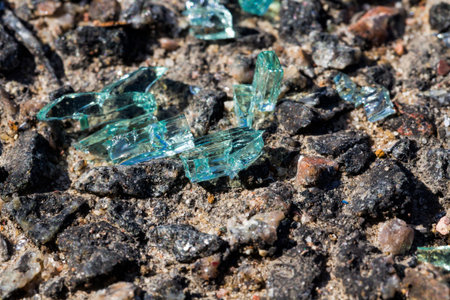 a lot of small broken glass from the car on the asphalt after an accident committed with the car,...