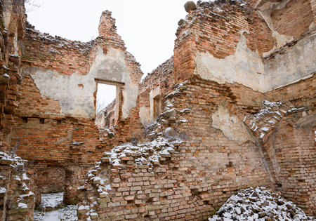 old clay orange bricks in an abandoned ruined red brick building, castle ruins in Europe
