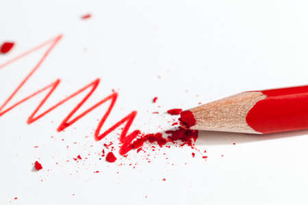 lines drawn with red pencil on ordinary paper of poor quality, closeup of homemade Amateur drawing and broken red pencilの写真素材