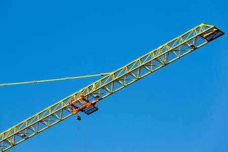 one construction metal crane for building houses with a large number of floors, against the skyの写真素材