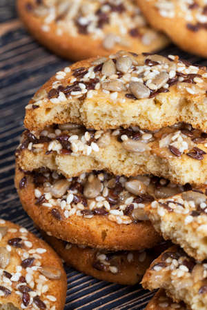 real tasty and fresh oatmeal-wheat cookies sprinkled with nuts and seeds of different typesの写真素材