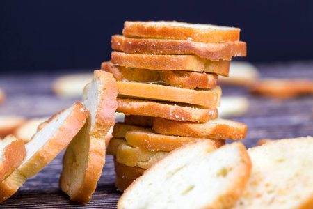 rye crackers with spices, close-up of food made from wheat or other flour. small crackers for a...