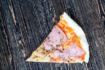 one pizza stuffed with ham, cheese, and herbs and other ingredients, inexpensive fast food , unhealthy foodの写真素材