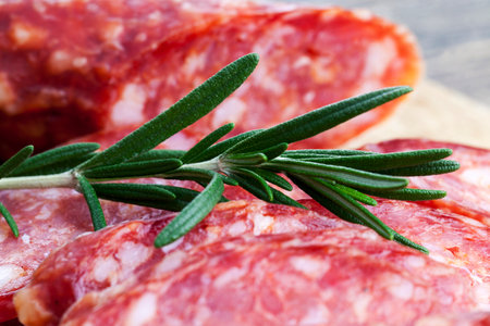 meat prepared marinated beef, pork products with lard sliced on the table with rosemaryの写真素材