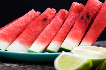 slices and chunks of red juicy watermelon sliced on the table, natural food product