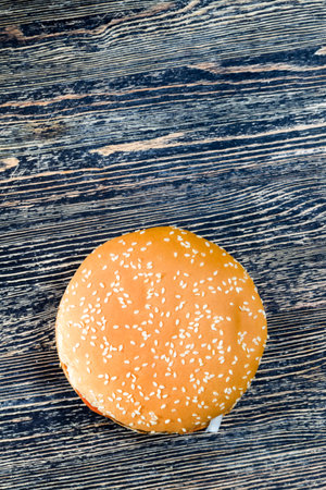 one sesame bun stuffed with meat, cheese, and herbs and other ingredients, inexpensive fast foodの写真素材