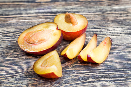 sliced homemade plums while cooking, delicious and healthy ripe plums , plum fruit details, closeupの写真素材