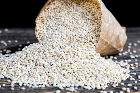 a large amount of raw grain of pearl barley, not cooked but ready for cooking pearl barley to get a...