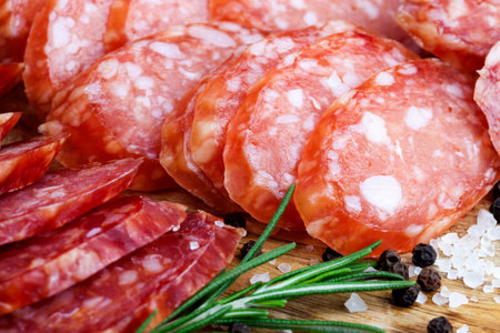 useful meat products made in a meat factory, close-up of sliced meat with green fresh spicesの写真素材