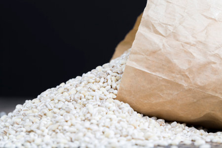 a large amount of raw grain of pearl barley, not cooked but ready for cooking pearl barley to get a delicious and high calorie porridge, pearl barley, close upの写真素材