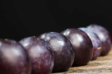 red homemade plums during cooking, delicious and healthy whole plums that are ripe , closeupの写真素材