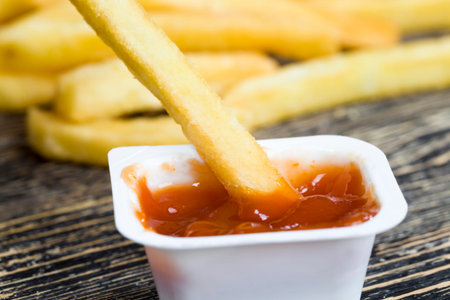 fresh French fries are inexpensive convenient fast food, unhealthy food, natural deep-fried...