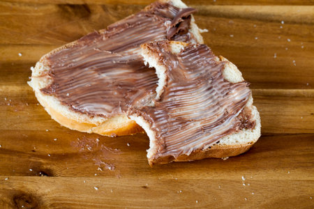 natural chocolate paste with cocoa during breakfast, sliced white bread with smeared chocolate...