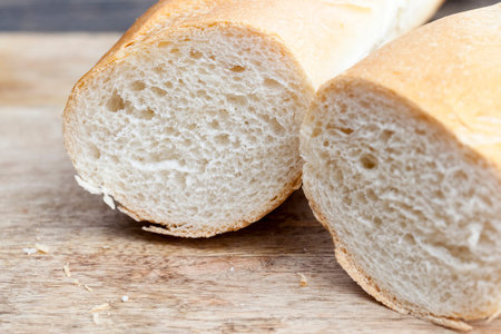 sliced white wheat baguette, a loaf of wheat baguette cut into slices, a baguette used for making...