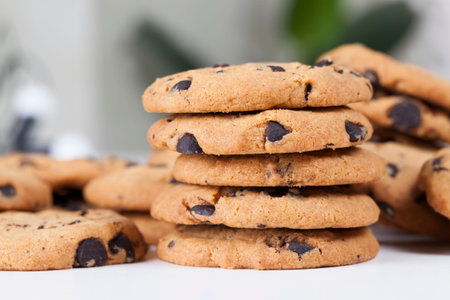 drops and pieces of chocolate in traditional wheat cookies, food for tea or coffee, sweet and...