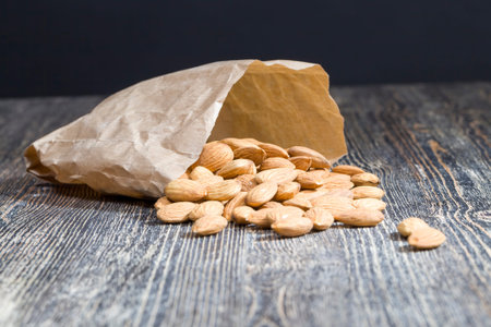 quality raw nuts ready to eat, almonds on the kitchen table during cooking, almonds fresh and...