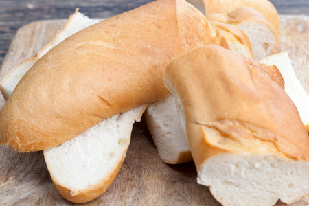 sliced white wheat baguette, a loaf of wheat baguette cut into slices, a baguette used for making...