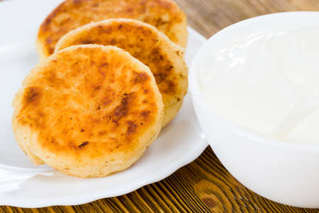 Several curd cheesecakes lying on a white plate, close-up of food, Eastern Slavic cuisineの写真素材