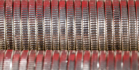 A large number of coins lying together having red hues from lightingの写真素材