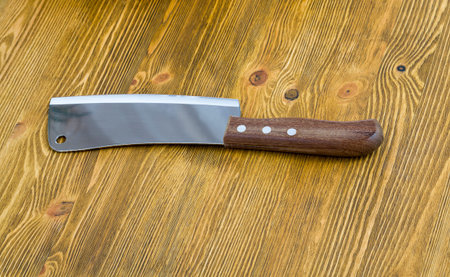 big old cleaver lying on a wooden table, closeup