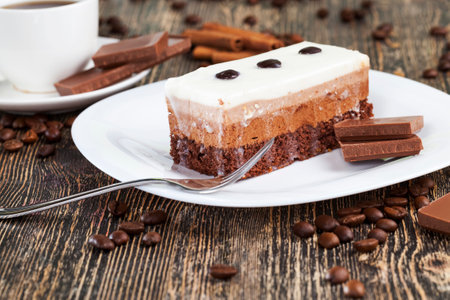 chocolate cake taste and black coffee, coffee with chocolate and multi-layer cake for dessert, delicious piece of cake in which each layer with its own color and tasteの写真素材