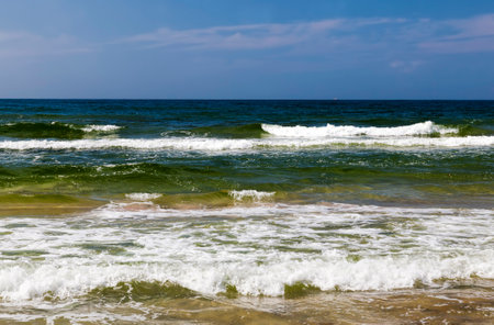beautiful sunny weather on the sea coast, cold summer weather on the Baltic Sea, seascape on the sea on a sunny day with a blue skyの写真素材