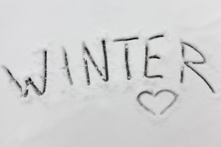 the word winter on snow in the winter season, snowy frosty weather and the description about winter on freshly fallen snowの写真素材