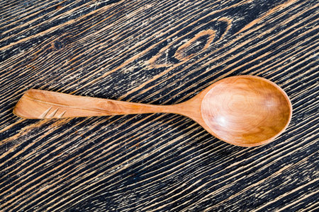 a few simple wooden spoons made of natural wood, a closeup of useful items in cooking and other activitiesの写真素材