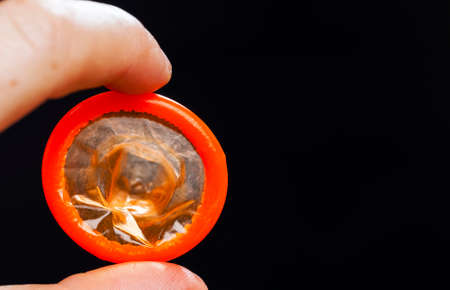 one quality orange latex condom, the condom is not in the package, made of natural latex to prevent diseases and pregnancyの写真素材