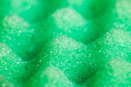 green sponges for washing dishes and other items, closeup of kitchen spongesの写真素材