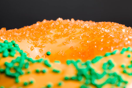 covered in mango flavored chocolate a fresh sweet donut sprinkled with orange colored sugarの写真素材