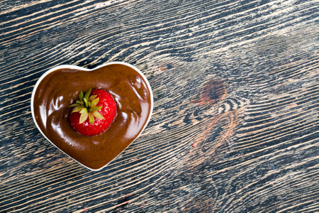 chocolate-covered red berries of ripe strawberries, close-up of high-calorie products, strawberries grown on an organic farmの写真素材