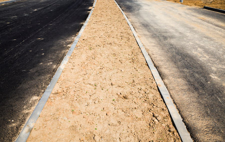 construction of a new road in a new modern area, construction site in the construction of an asphalt...