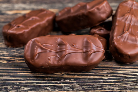 real milk chocolate made from cocoa and sugar with milk powder, closeup of cocoa products and other...