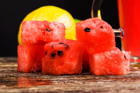 slices and chunks of red juicy watermelon sliced on the table, natural food product, closeupの写真素材