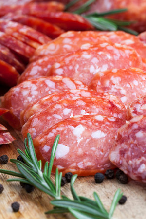 meat prepared marinated beef, pork products with lard sliced on the table with rosemary