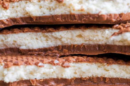 delicious and sweet chocolate made from cocoa and sugar, details and close-up of products made from cocoa and white fillingの写真素材